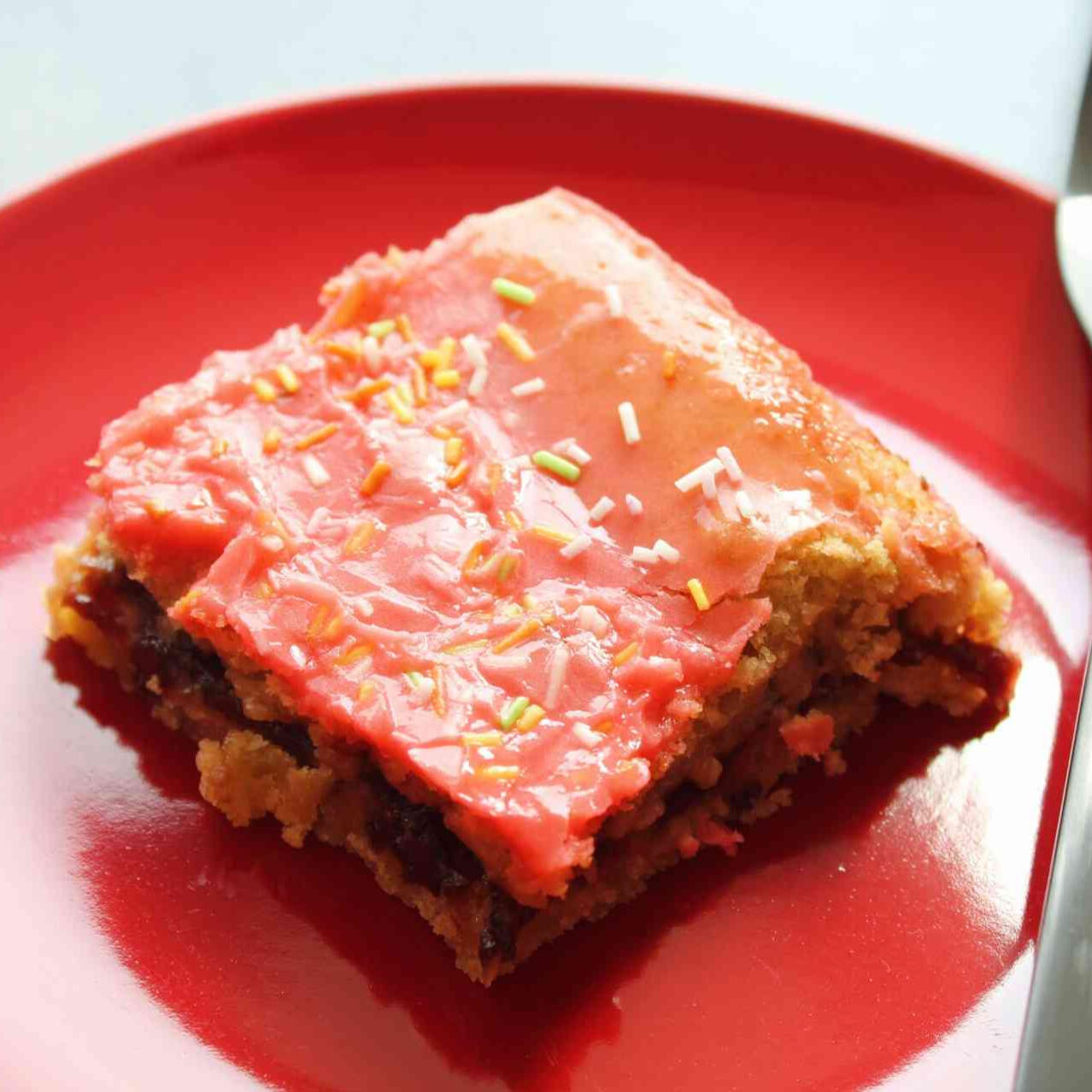 A photo of one cherry flavored bar on a red plate.